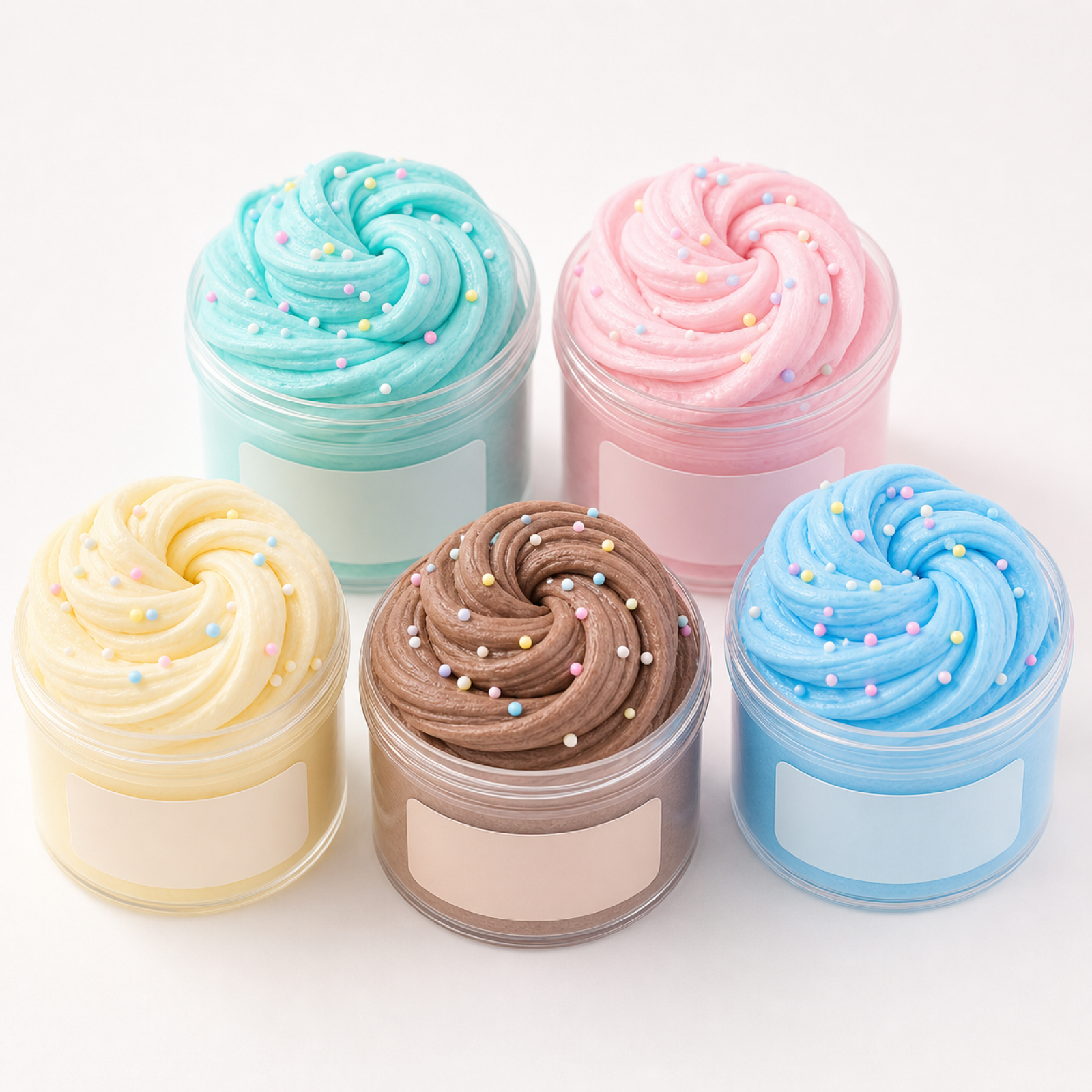 Five pastel butter slime tubs arranged on a clean white background
