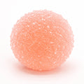 Peach pink crystal mochi squishy stress ball on a clean background