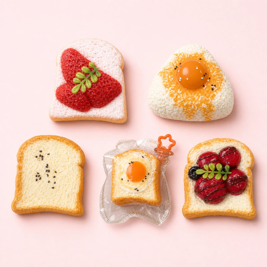 Handmade food-shaped Taba squishy toys arranged on a clean pastel background