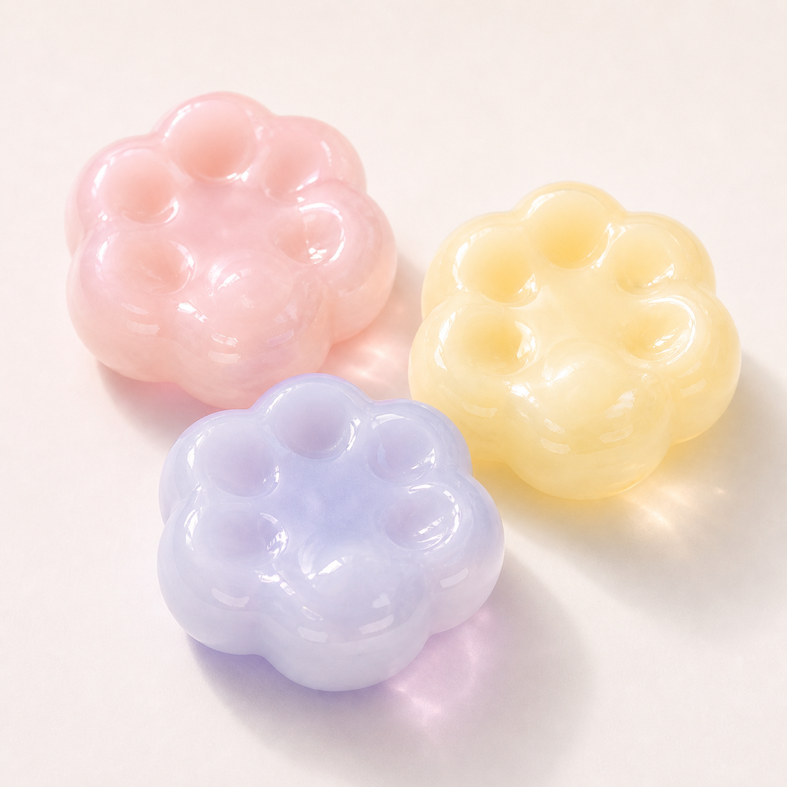 Glossy handmade mochi squishies with scalloped dimples on a clean background