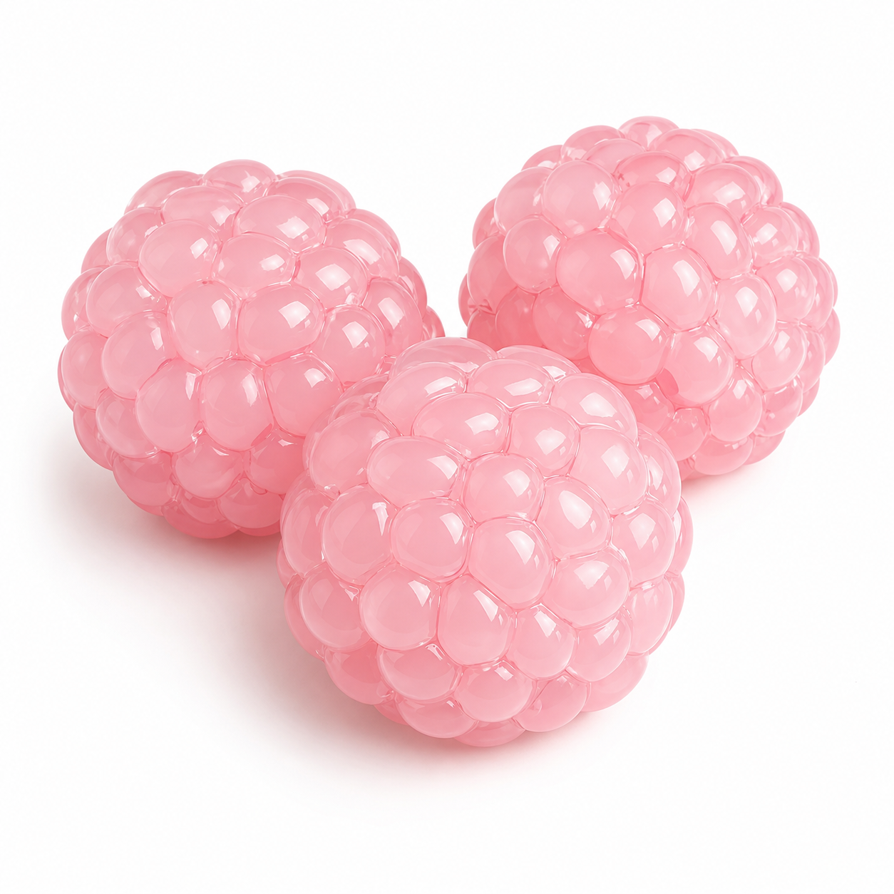 Pink grape bead stress balls on a clean warm white background