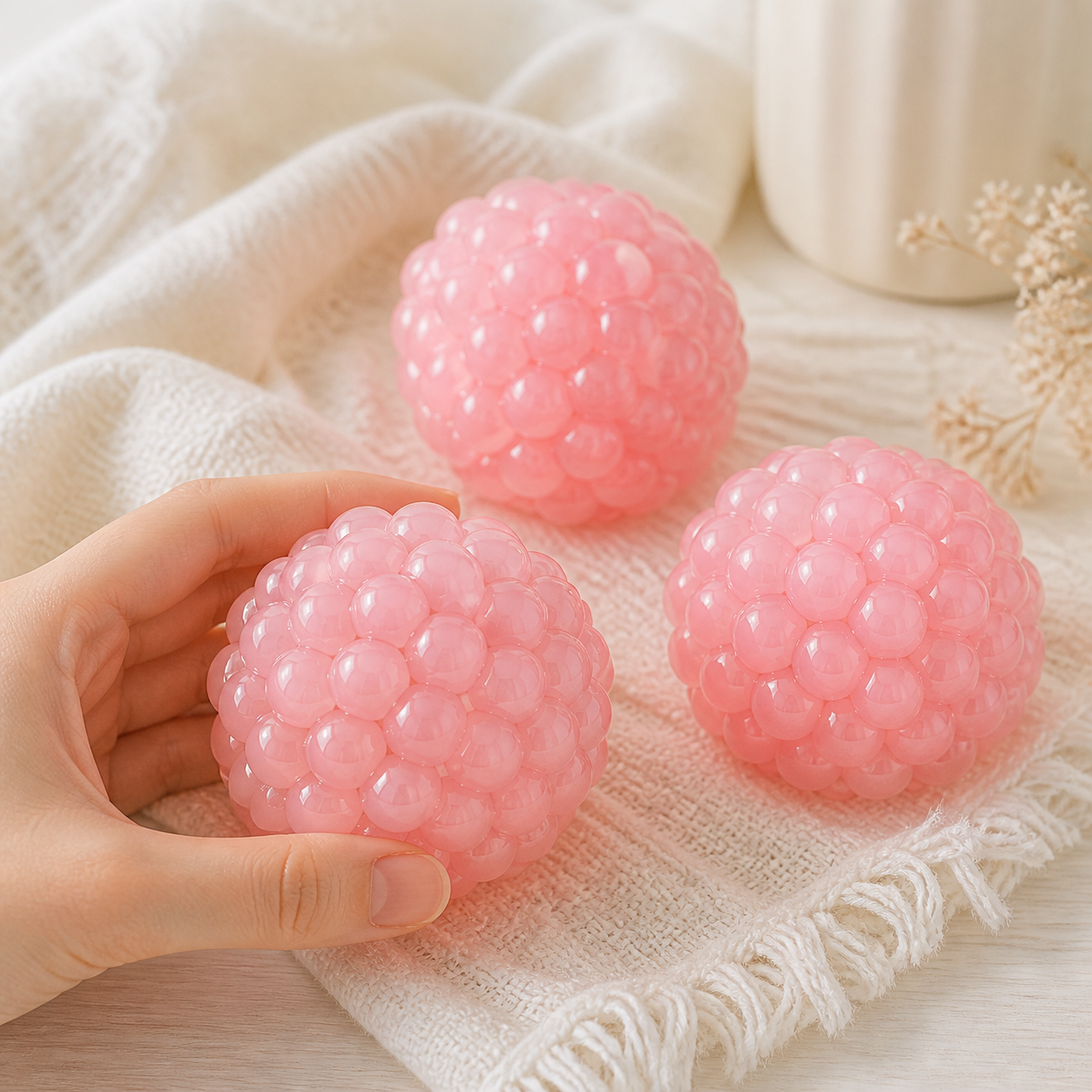 Pink grape bead stress balls in a soft cozy lifestyle scene
