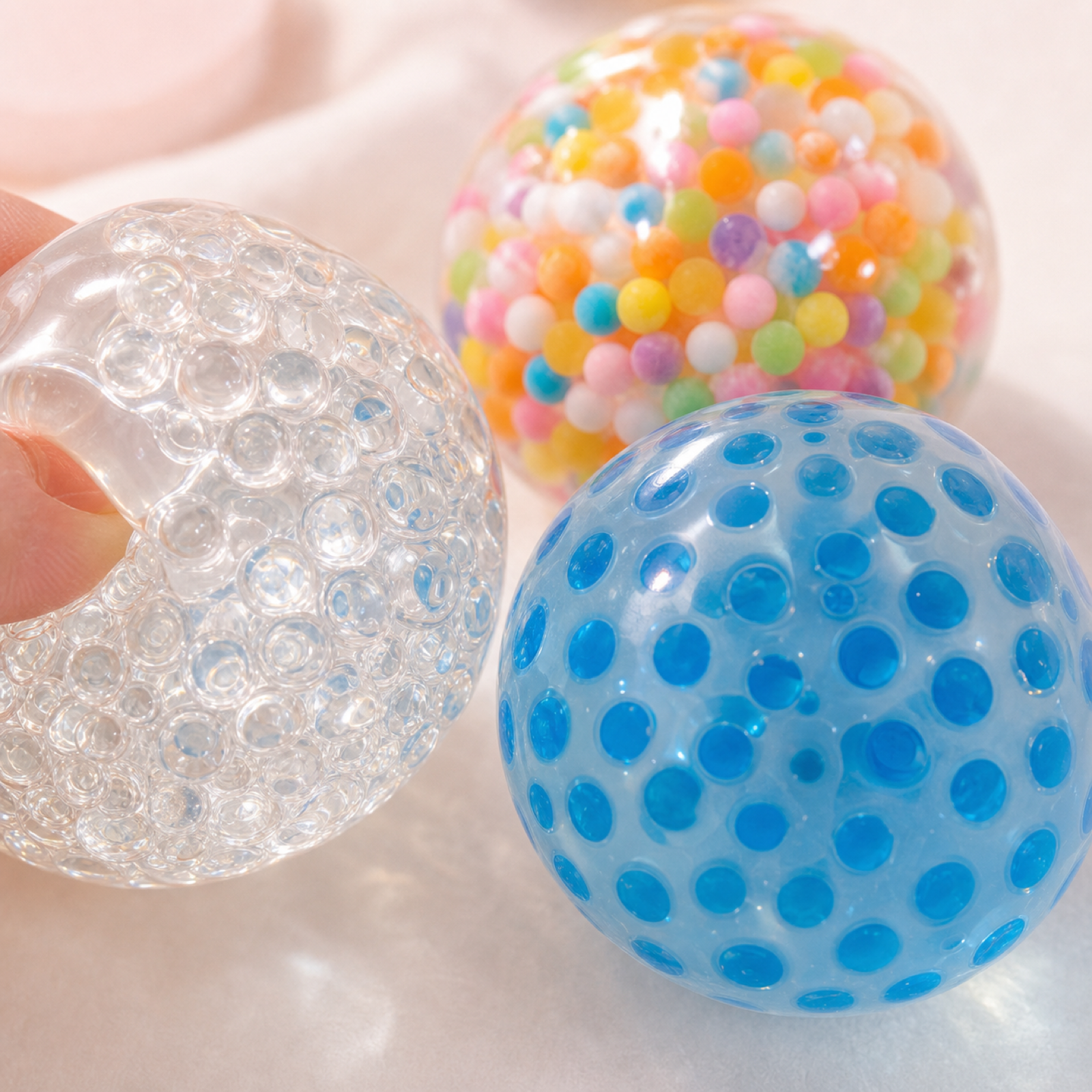 Close-up of translucent bead and dotted stress ball textures